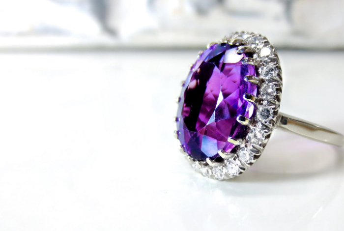 a ring with big purple diamond